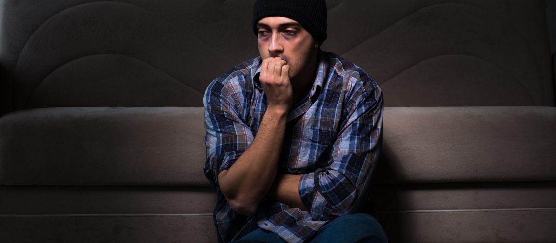Young man in agony having problems with narcotics