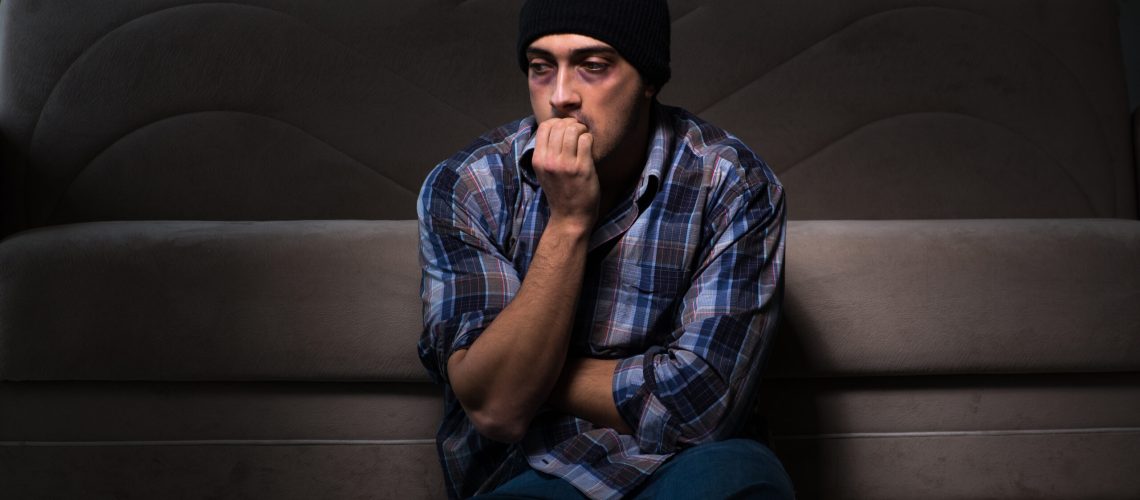 Young man in agony having problems with narcotics