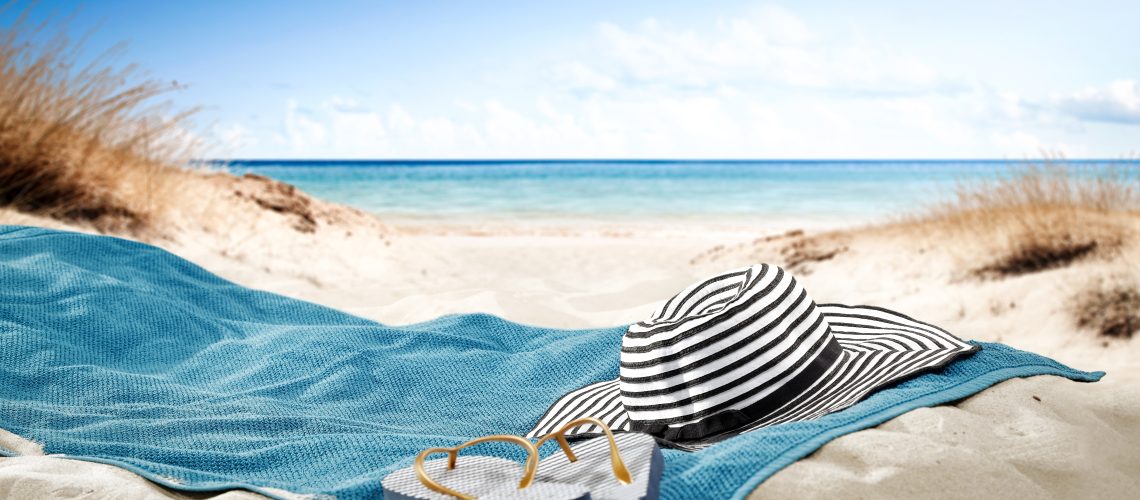 blue towel with hat and summer beach
