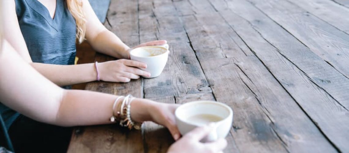 two women drinking coffee after opioid treatment